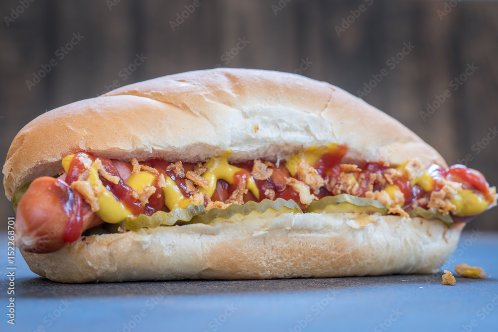 Grilled hot dogs with mustard, ketchup and dill pickles Grilled hot dogs with mustard, ketchup and dill pickles