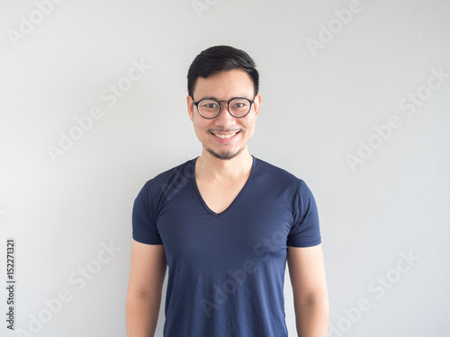 Smiling Asian man with eyeglasses.