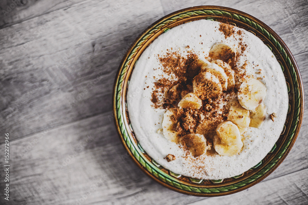 ice cream with bananas and nuts on aged background ice cream with bananas and nuts on aged background