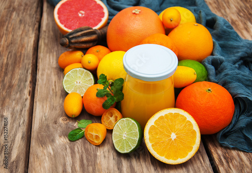 Jar of juice and fresh citrus fruits