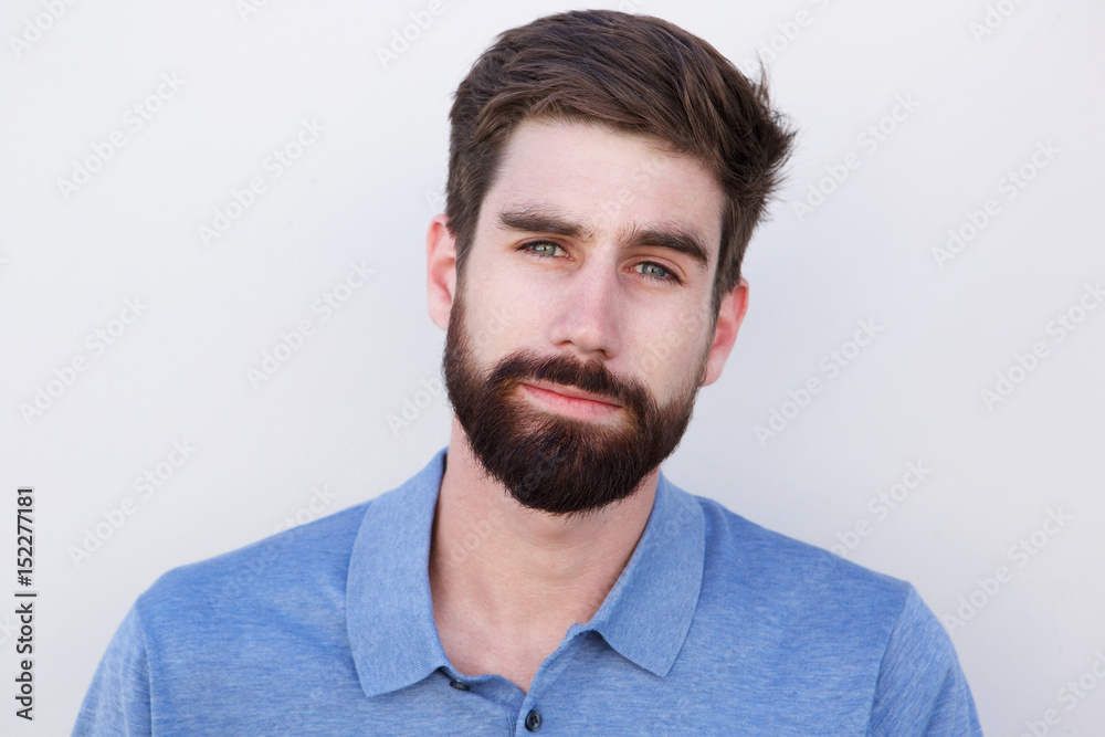 Close up handsome young man with beard against white background Close up handsome young man with beard against white background