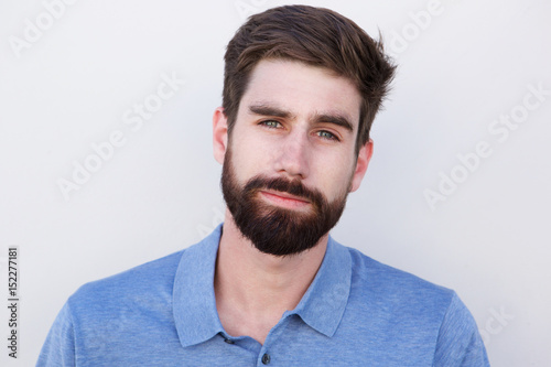 Close up handsome young man with beard against white background