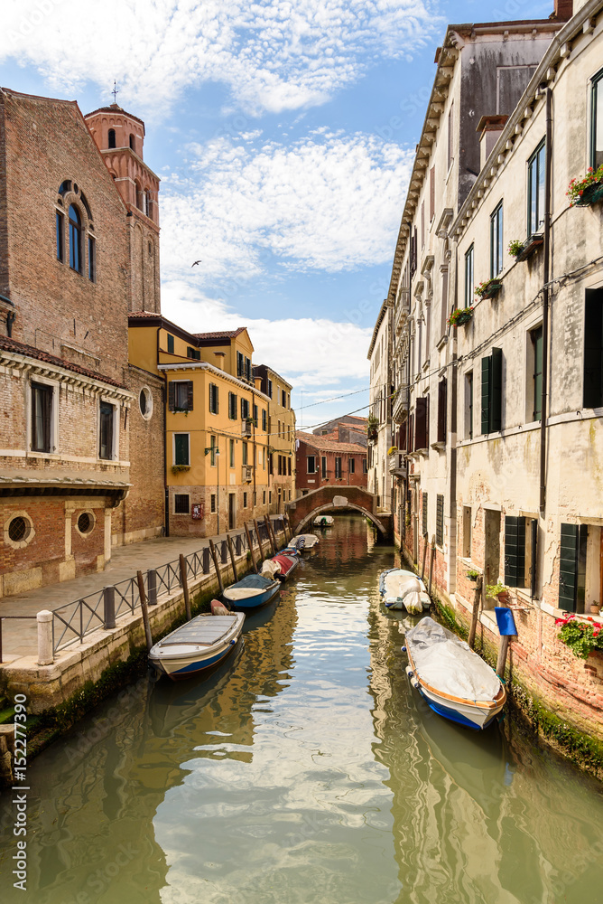 houses and boats along the canal of Venice, Italy