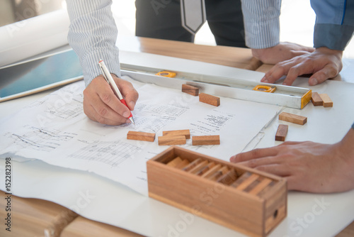 Team of engineers discussing a blueprint