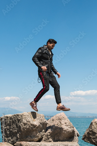 Handsome man jumping in a vacation context