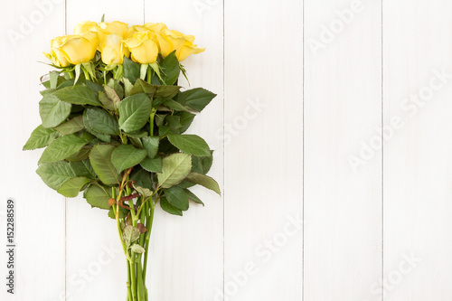 Bouquet of roses on white wooden background