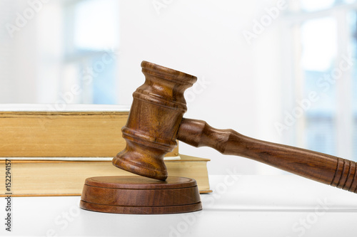 Wooden gavel and books on wooden table