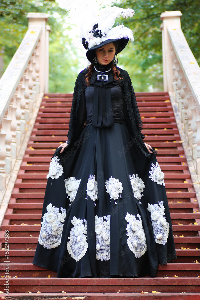 girl in old retro dress on stairs outdoor