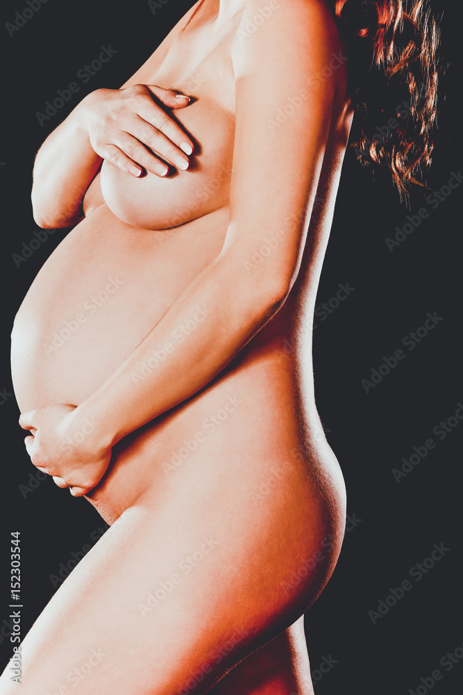 Side view of naked pregnant woman