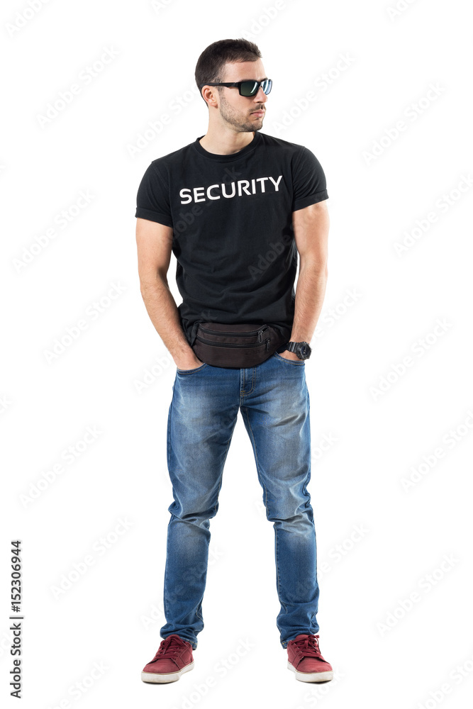 Undercover police officer in plainclothes with hands in pockets looking away. Full body length portrait isolated on white studio background. 