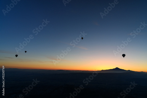 Hot air balloons flying over valley at sunrise. Cappadocia. Turkey