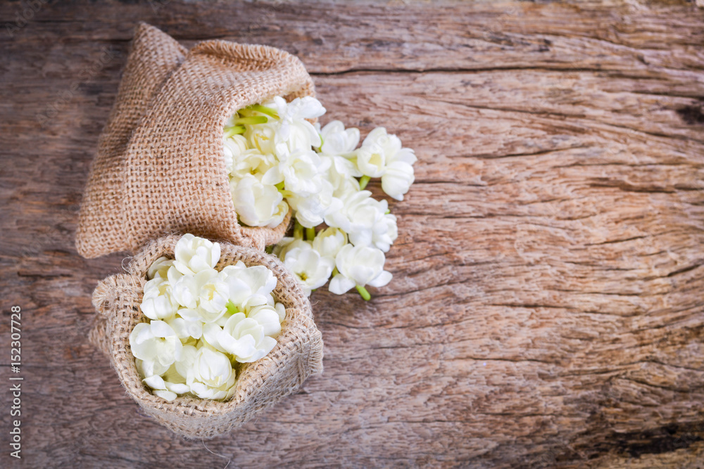 Jasmine flower in burlap bag on old wood background,select focus Jasmine flower in burlap bag on old wood background,select focus