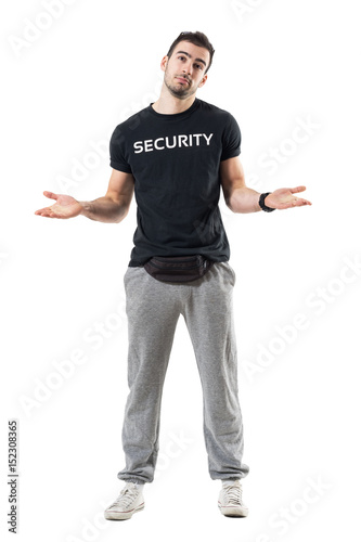 Confused uncertain bouncer or plainclothes officer shrugging shoulders. Full body length portrait isolated on white studio background.  photo
