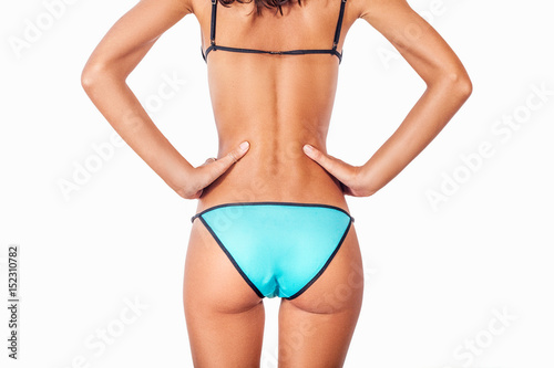girl in a bathing suit is worth turning your back to the camera with beautiful buttocks and keeps his hands on the sides of a close-up