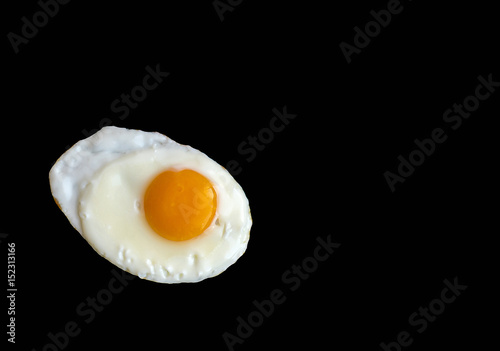 Fried egg isolated on the black background, space for ideas