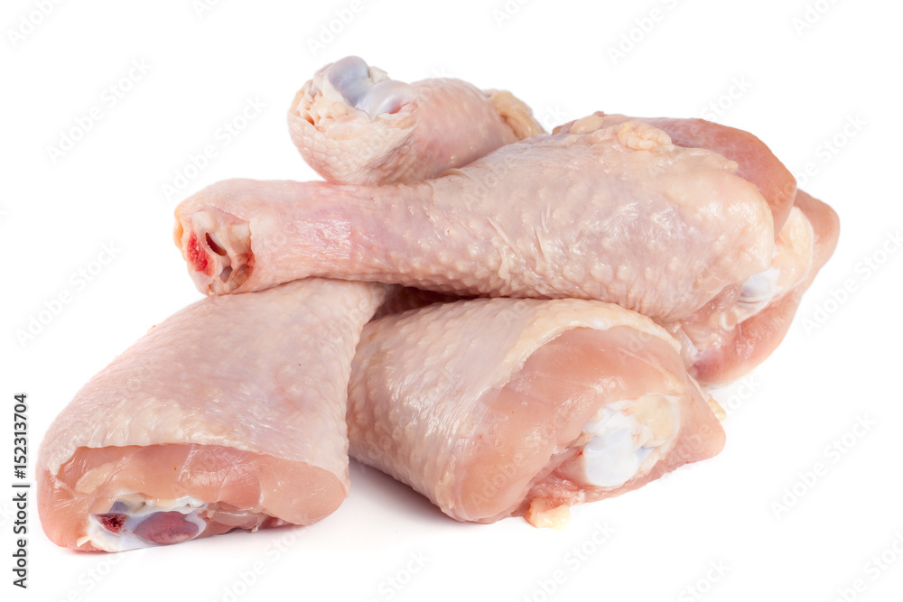 four raw chicken drumsticks isolated on white background four raw chicken drumsticks isolated on white background