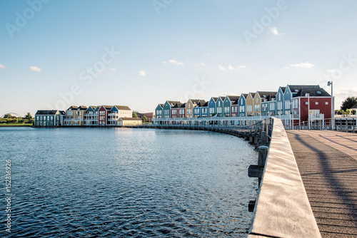 Colorful row houses in Houten, Netherlands, at dusk and reflections on water
