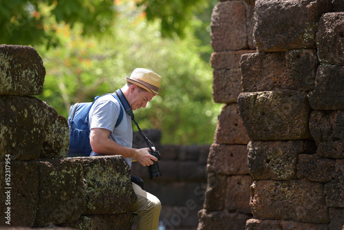  Travelers traveling with a camera in the old Thai temple. photo