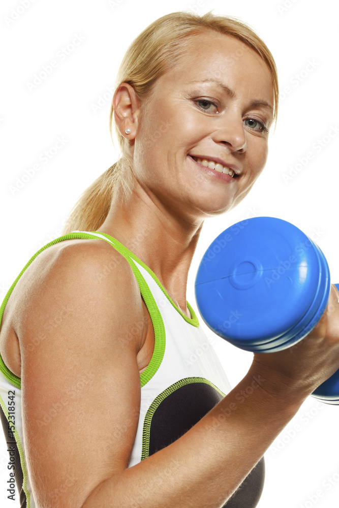 woman with dumbbells during training for strength