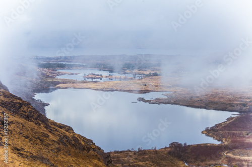 A beautiful irish mountain landscape with a lake in spring. Gleninchaquin park in Ireland.