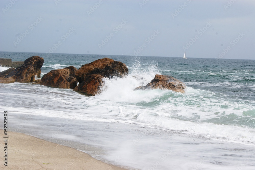 The sea, the blue aod, the waves are rooted about the stones. Summer, beach The sea, the blue aod, the waves are rooted about the stones. Summer, beach