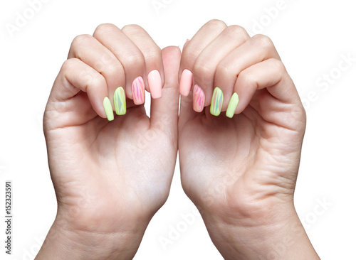 Female hands with woman's professional natursl pink and green nails manicure on white photo