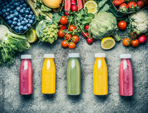 Vászonkép Variety of colorful Smoothies or juices bottles beverages drinks with various fresh ingredients: fruits ,berries  and vegetables on gray concrete background , top view