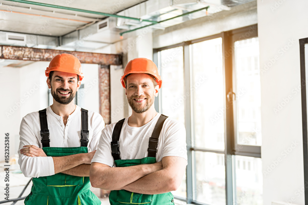 Hilarious smiling constructors folding hands Hilarious smiling constructors folding hands