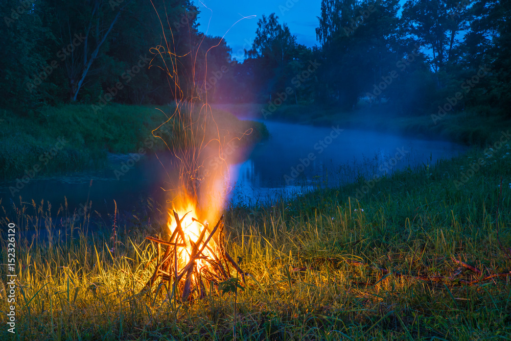 Burning logs in orange red bonfire at night Burning logs in orange red bonfire at night