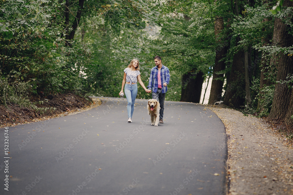 couple walking outdoors with her dog couple walking outdoors with her dog