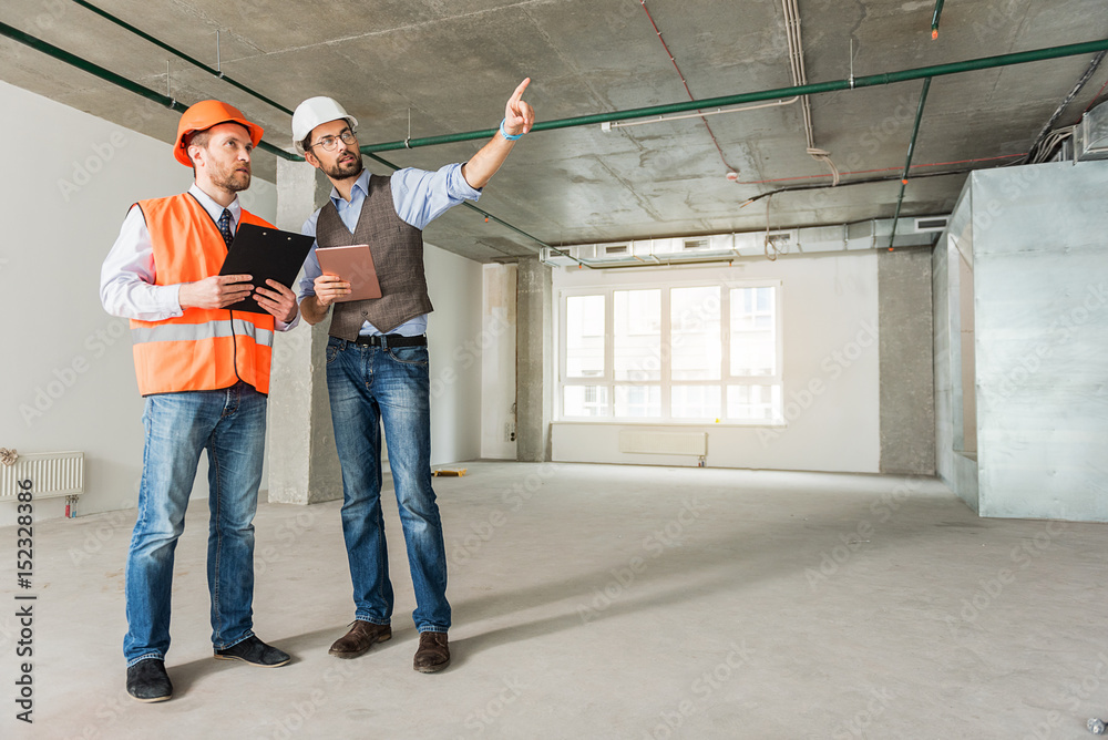 Concentrated builders keeping important documents Concentrated builders keeping important documents
