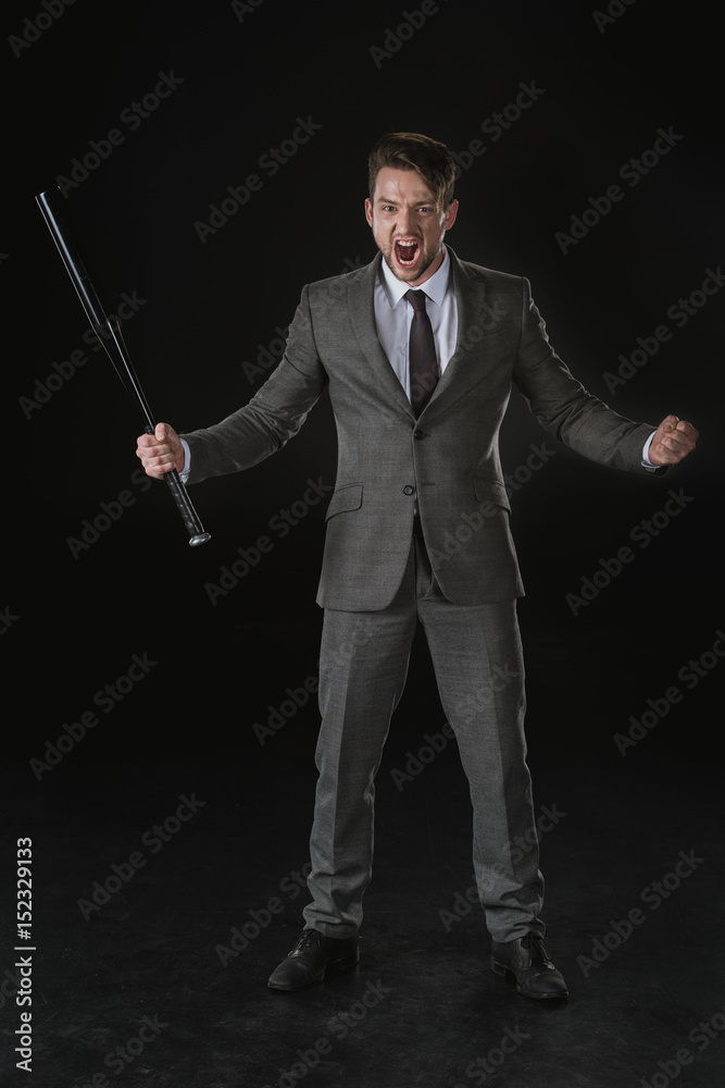 Angry businessman holding baseball bat and screaming isolated on black Angry businessman holding baseball bat and screaming isolated on black