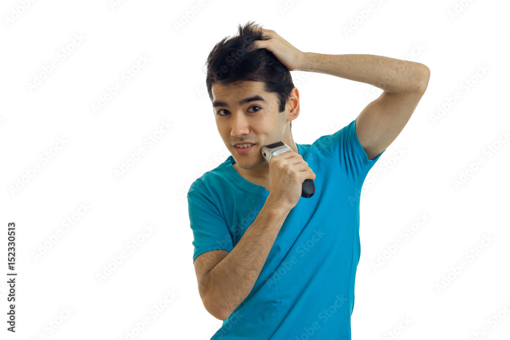 young cheerful man in blue shirt shaving his face young cheerful man in blue shirt shaving his face
