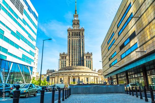 Palace of culture and science in Warsaw on sunny day with blue sky and green trees.  photo