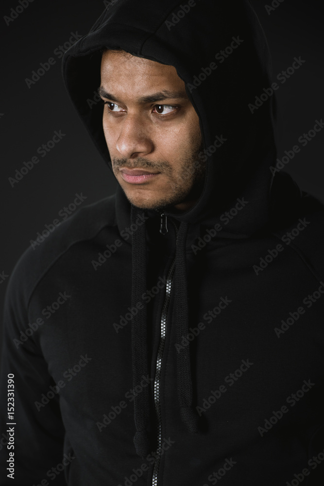 young african american man in zoodie isolated on black young african american man in zoodie isolated on black