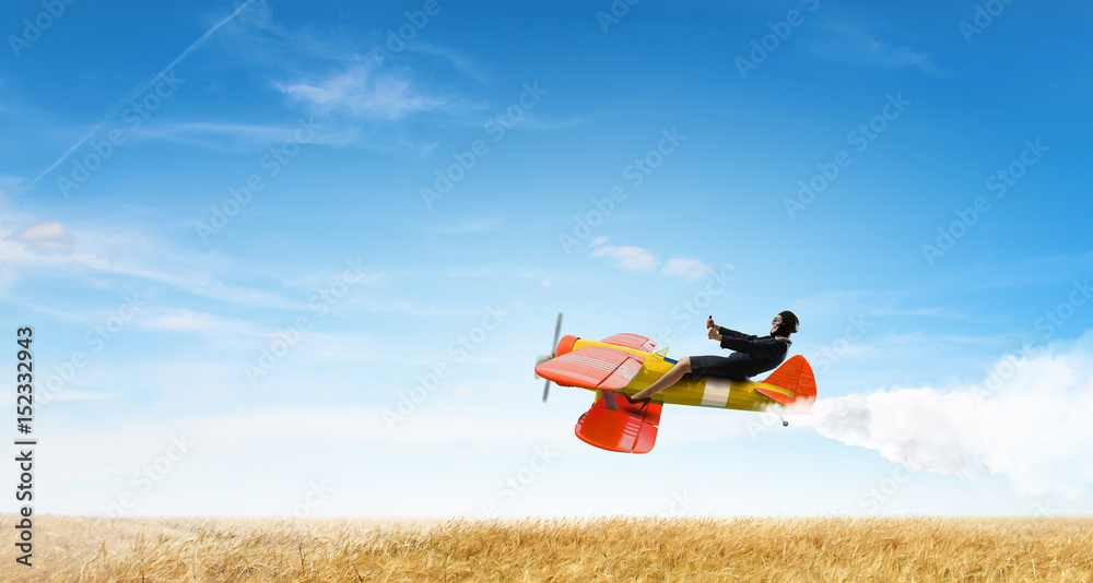 Fototapeta premium Woman in retro airplane . Mixed media
