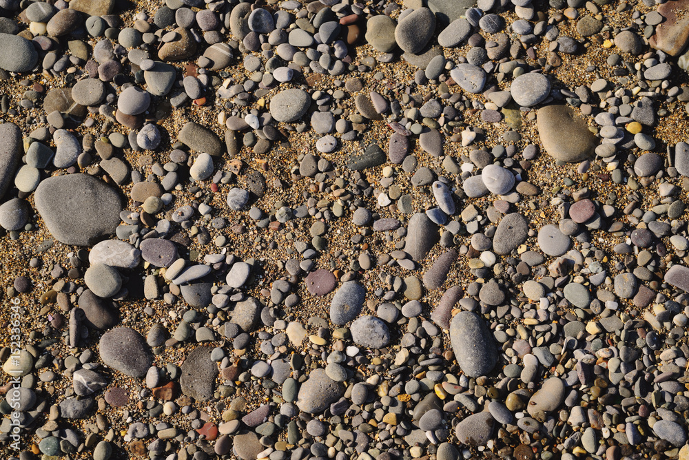 Background of sea pebbles on a sandy beach Background of sea pebbles on a sandy beach
