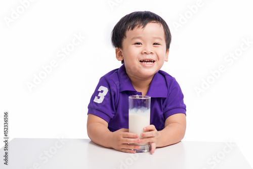 Little happy asian boy with glass of milk isolated on white background