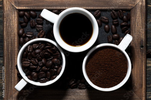 Three types of coffee - ground, grain and beverage, top view closeup