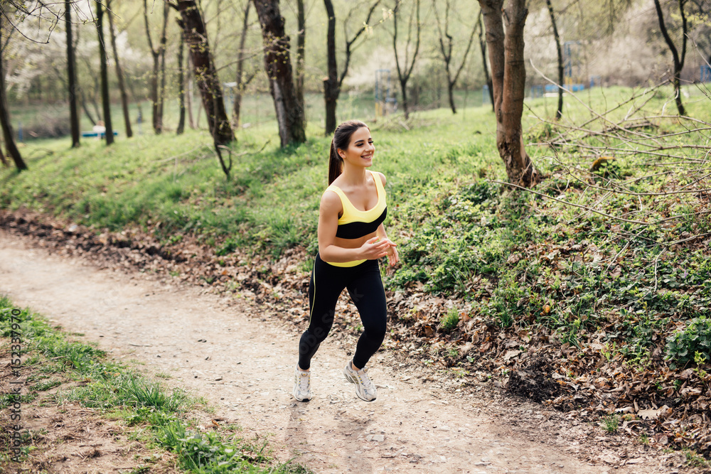Runner athlete running at tropical park. woman fitness jogging workout wellness concept. Runner athlete running at tropical park. woman fitness jogging workout wellness concept.