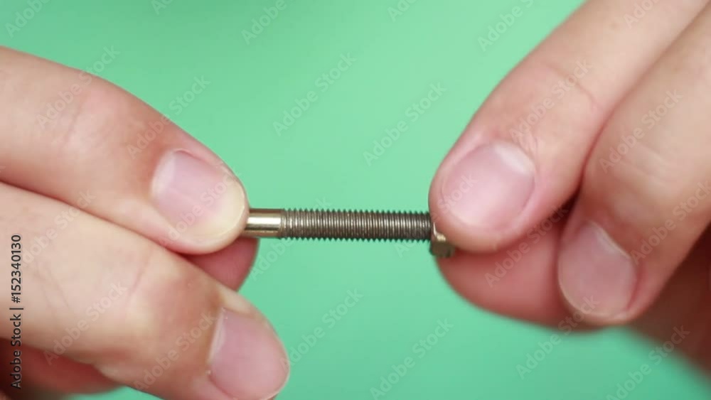 Twisting nut on bolt closeup Twisting nut on bolt closeup