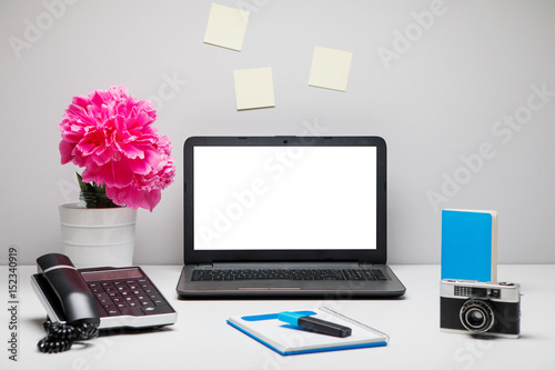 Stylish workspace with laptop computer, office supplies, camera,