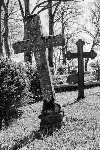Cross headstone in cemetery.