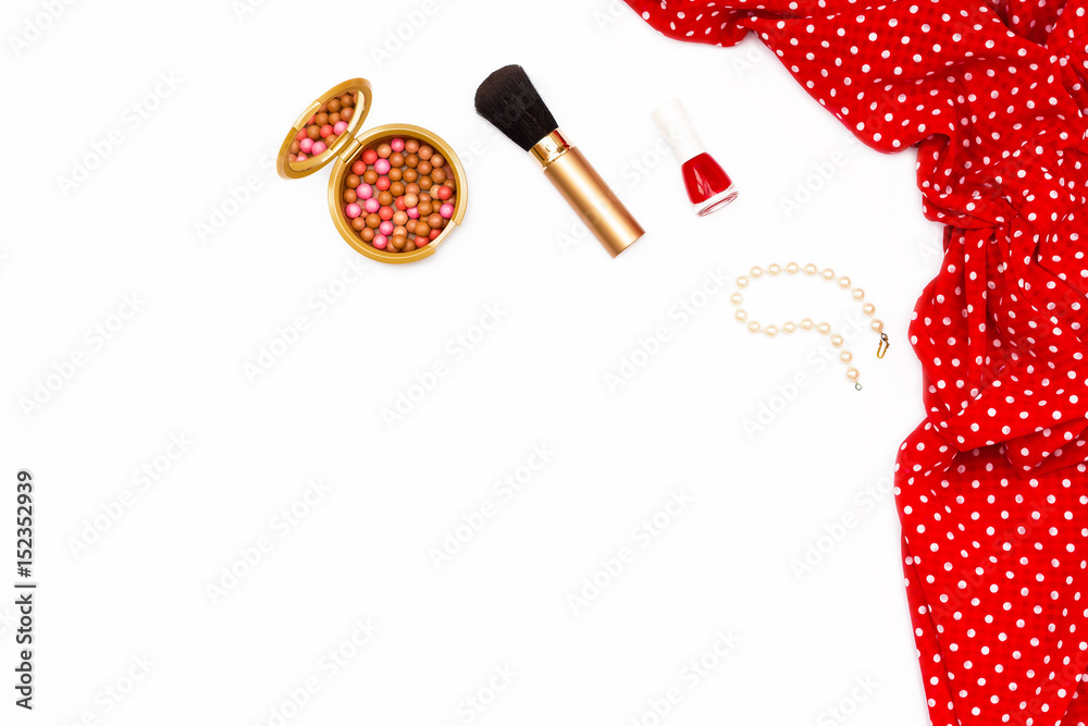 feminine red dress, nail Polish, pearl bracelet and makeup brush on white background. Minimal beauty concept.