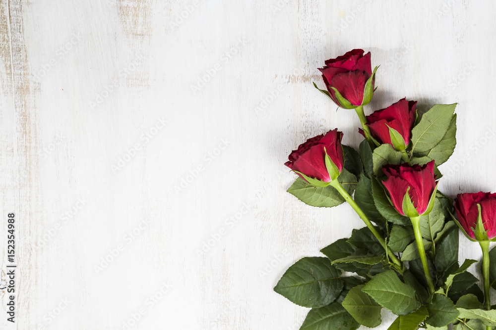 Red roses on a  wooden background.