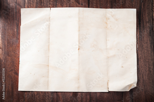 Vintage broken empty folded and crumpled paper on dark wooden table