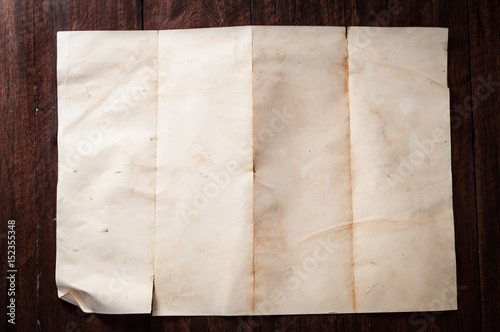 Vintage broken empty folded and crumpled paper on dark wooden table