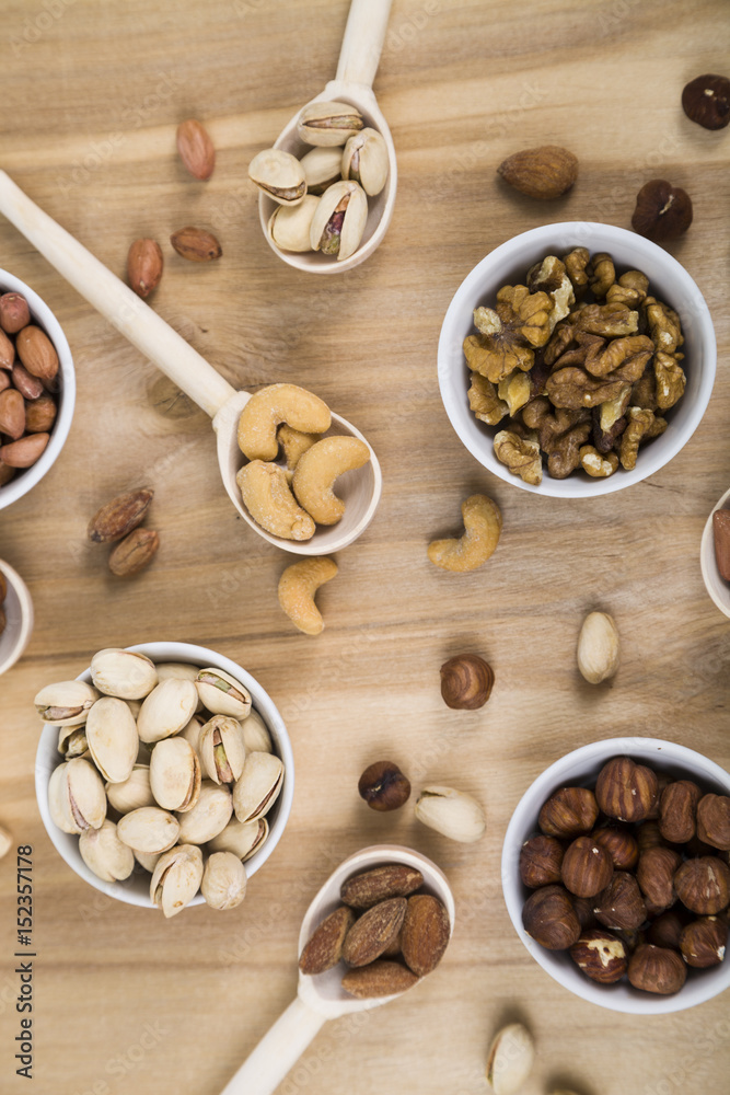 Nuts in a plate on a wooden table Nuts in a plate on a wooden table