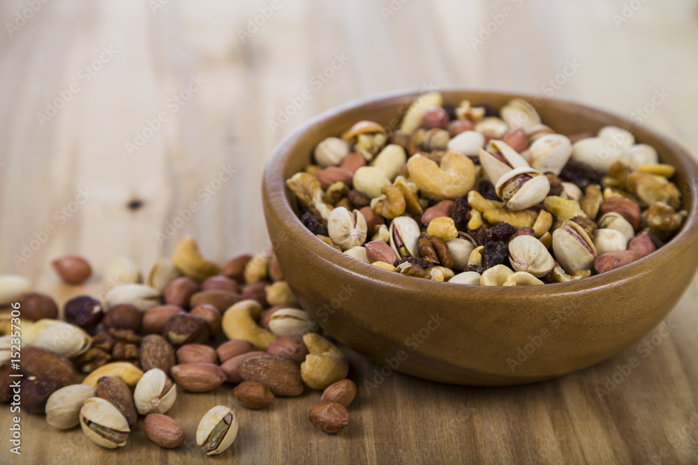 Nuts in a wooden bowl on a wooden table. Nuts in a wooden bowl on a wooden table.