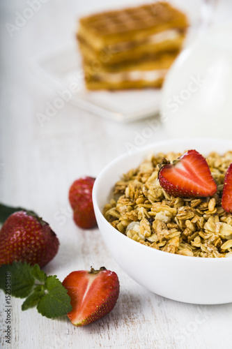 Muesli  smoothies  milk and fresh strawberries on a wooden table